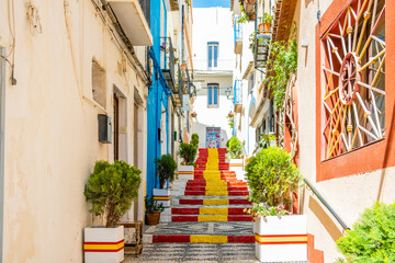 Stairs adorned with colors of Spanish flag, in Calpe old town. Alicante province, Valencian...