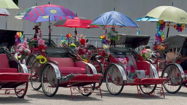 Trishaw bikes for public and tourist transport standing empty in front of the International Cruise Terminal, George Town, Penang, Malaysia
