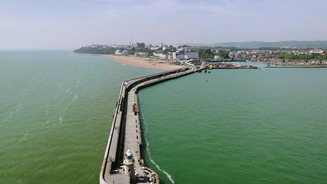 The drone aerial footage of Folkestone Harbour Arm and Folkestone city, England. Folkestone's restored Harbour Arm is a beautiful promenade out at sea with a World-class view. 