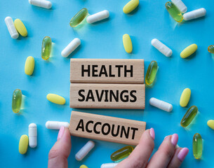 Health Saving Account symbol. Concept word Health Saving Account on wooden blocks. Doctor hand....