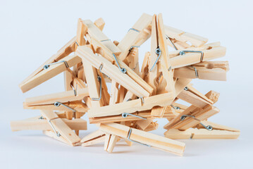 Pile of wooden clothespins isolated on white