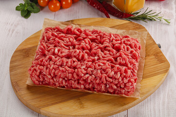 Raw minced beef meat over board