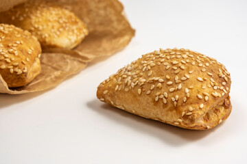 Israeli puff pastry Bourekas with cheese on white background.