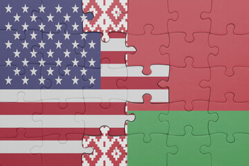 puzzle with the colourful national flag of belarus and flag of united states of america .