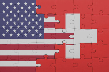 puzzle with the colourful national flag of switzerland and flag of united states of america .