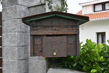 Charming Mailbox: Wooden House-Shaped Letterbox Adorning Exterior Home - A Quaint Touch of Rural...