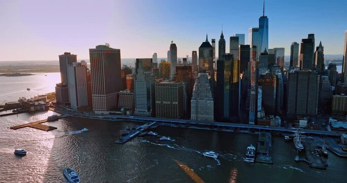 Majestic skyscrapers towering above the East River in New York, USA. Numerous boats and yachts float by the waterscape. Top view.