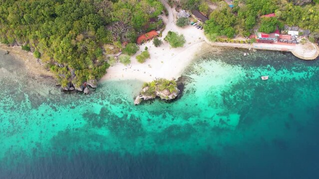 4K Aerial Drone video of famous platform jumping spot in the crystal clear turquoise water, Salagdoong beach in Siquijor island, Philippines