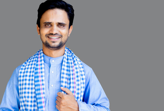 Smiling Indian man in traditional blue kurta and checkered gamcha