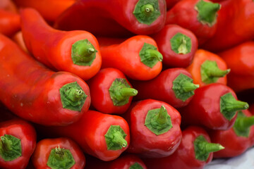 Background pattern of stacked peppers on sale at the market