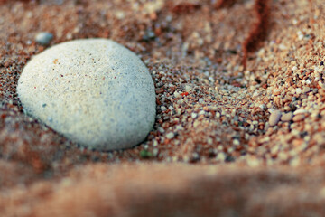 Wet pebbles and sand on the seashore. Bokeh. Black sea, Crimea.