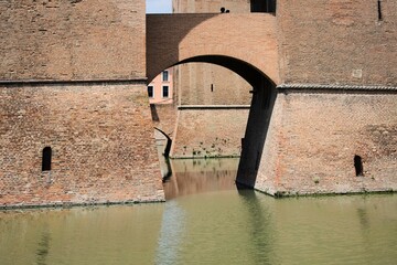 The moat of the famous medieval Este castle (Castello Estense) of Ferrara, italy  (UNESCO)