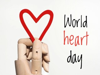World heart day poster. A hand holding a red heart and text on a white background