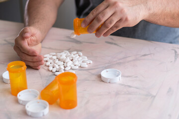 Person falling in drugs and adicted in horizontal view and bottles of drugs