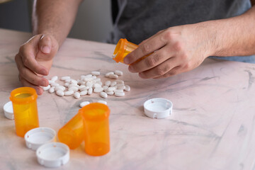Person falling in drugs and adicted in horizontal view and bottles of drugs