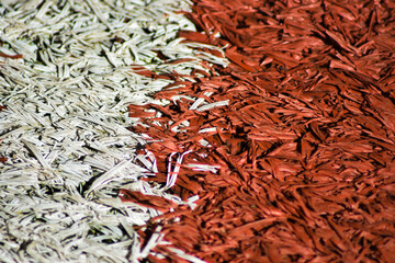 Grass textured background pattern with red white stripes