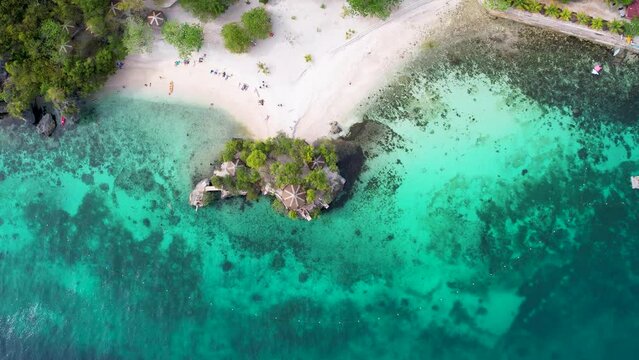 4K Aerial Drone video of famous platform jumping spot in the crystal clear turquoise water, Salagdoong beach in Siquijor island, Philippines