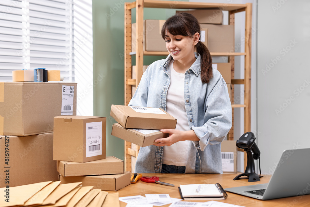 Poster Parcel packing. Post office worker with parcels at wooden table indoors