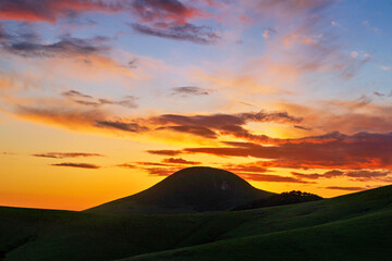 Sunset with silhouetted mountain , hill, sunrise, sky and clouds