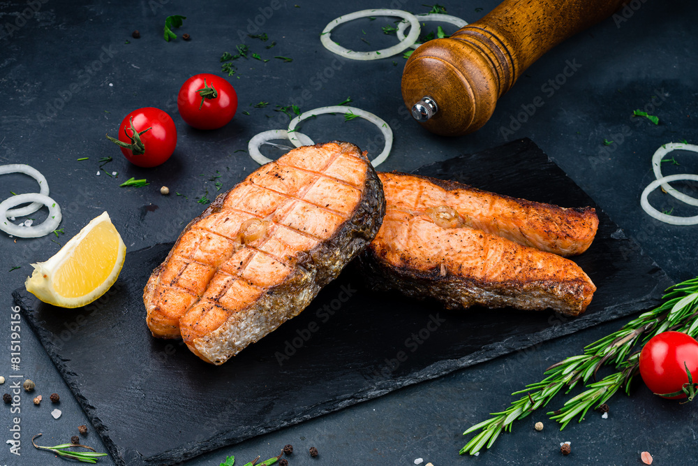 Canvas Prints Grilled salmon fish on black stone background