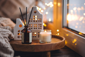 Banner. Christmas home aromatherapy. Cozy atmosphere, holiday spirit. Winter inspiration. Aroma diffuser with pine extract, organic essential oil, vanilla, gingerbread cookies, candles on wooden table