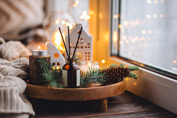 Cozy Christmas atmosphere at home. Holiday scent, aromatherapy. Fir tree fragrance, winter mood,...