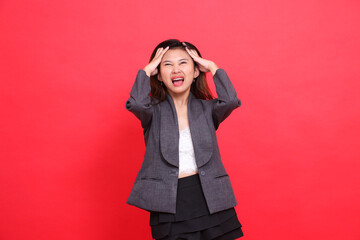Asian office girl expression severe pain headache both hands holding it candid wearing gray jacket...