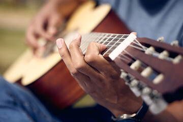 Hands, man and playing guitar in garden for music, sound and performance in nature. Male person,...