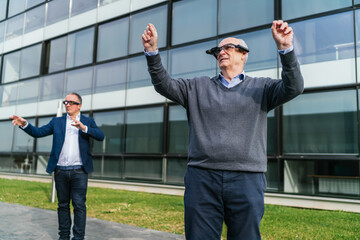 Two businessmen engaging with virtual reality technology outdoors, using VR glasses to interact with the digital environment.