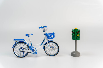 Miniature bike placed next to a working traffic signal.