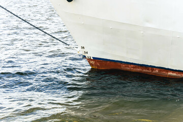 A boat is securely docked in the water with a rope tied to it
