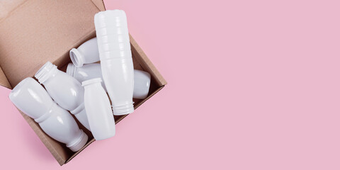 White plastic bottles neatly packed in a cardboard box
