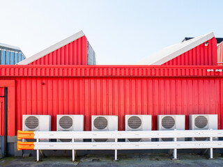 Air conditioning units outside red food factory or plant. Keeping low temperature for health and...