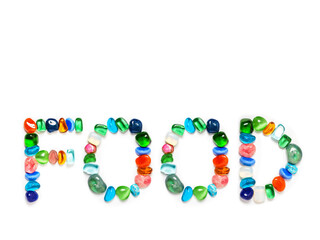 Sign food on white background made from colorful gems. Copy space. Natural art.