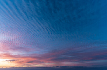 Stunning view of the sky at sunset, showing a beautiful mix of colors and cloud formations. Filled...