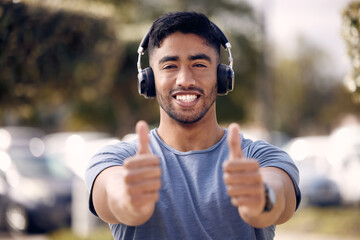 Man, portrait and thumbs up with headphones for exercise playlist or radio streaming, approval or...