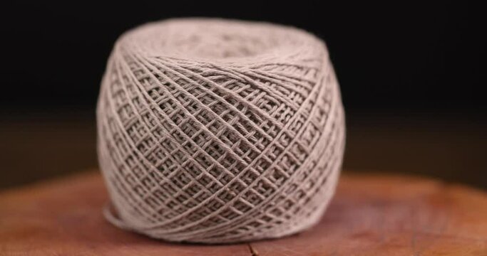 fine cotton thread for knitting and embroidery, close-up of a ball of light-colored thread for needlework