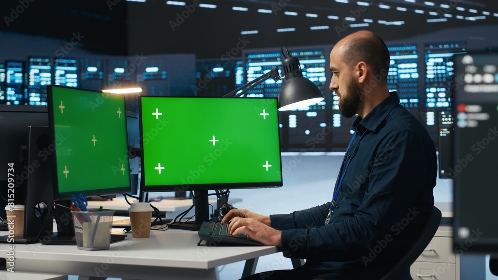 Poster it supervisor working on isolated screen computers in data center, ensuring optimal performance. per