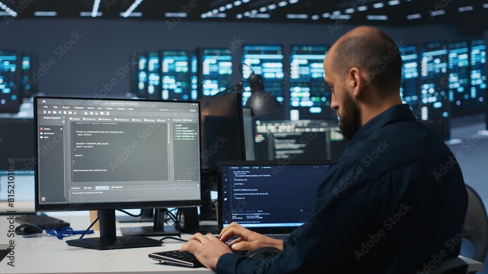 Poster developer typing code, working in network security data center facility, ensuring optimal performanc