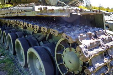 tracks and wheels of tank t80, armored vehicles on the street in green khaki color