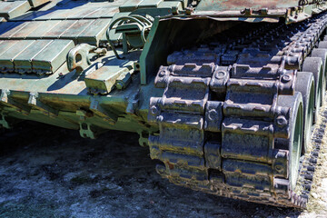 tracks and wheels of tank t80, armored vehicles on the street in green khaki color
