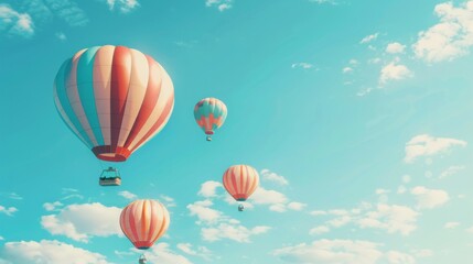 Obraz premium Multiple striped hot air balloons ascend gracefully against a backdrop of a serene blue sky with wispy clouds.