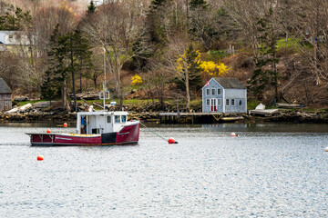commercial inshore fishing boat  moored in a beautiful sheltered cove on nova scotia's south shore shot spring room for text