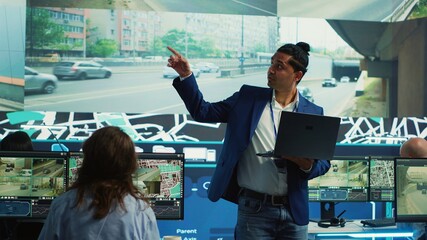 Indian supervisor handles order delivery logistics by monitoring cars route with gps coordinates...