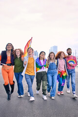 Vertical. Young LGBT community joyful diverse friends strolling together on day gay pride parade city. Happy rainbow colorful people enjoy smiling hugging walking outdoors. Gen z sexual liberation. 