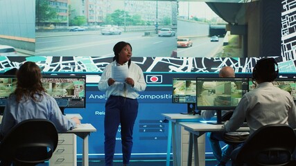 African american manager provides information for delivery parcels to her diverse team, people...