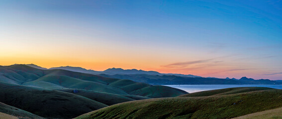 Sunrise, sunset over the hills, ocean, lake from a view