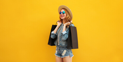 Shopping day! Stylish beautiful happy smiling young woman with black shopping bags, wear summer hat