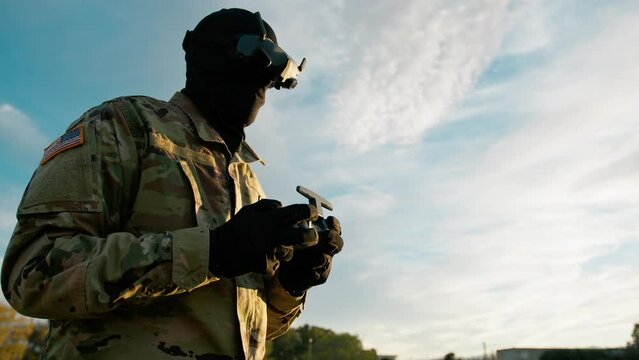 American Air Force Drone Pilot With Remote Control Outdoors At Daytime