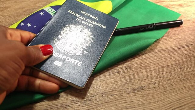 close up of a hand holding a brazilian passaport